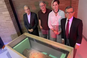 image of 4 people standing around Maya incense burner