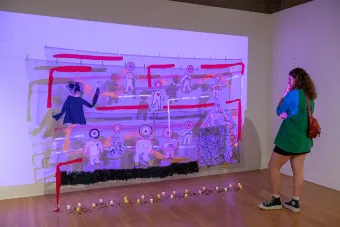 A student views a sculpture in a gallery