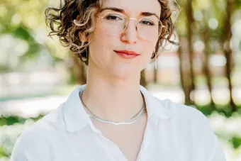headshot image in front of greenery