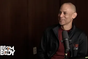Charles Carson sitting with a microphone