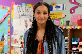 Headshot of Haley Kim against the backdrop of a classroom