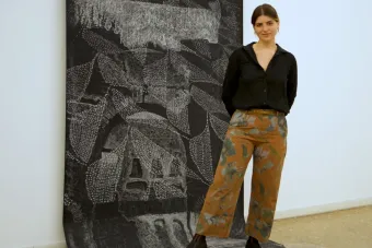 image of a person standing in front of an artwork
