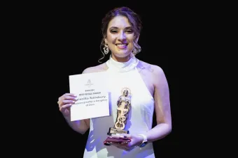 Priscilla Salisbury winning an award with a black background