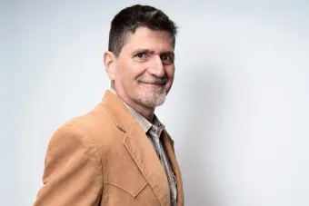 headshot in front of gray background