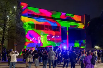 exterior of fine arts building with colorful projections