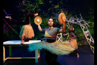 A woman in a grass skirt spinning