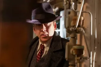 man in a fedora and 40s era suit