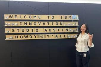 Design student Emmy Chen flashes the Hook'em hand sign