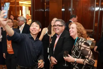 Dean Ramón H. Rivera-Servera and Butler School of Music Director take a selfie with a guest at a Texas Global event in Seoul, South Korea