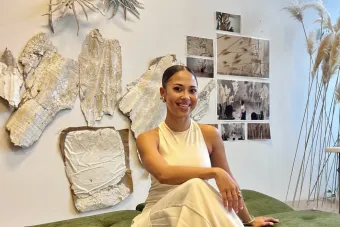 Artist and St. Elmo fellow Taisha Carrington sitting in front of her work