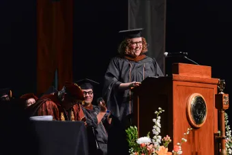 Alumna and playwright Kimberly Belflower speaks at the UT College of Fine Arts commencement in 2026