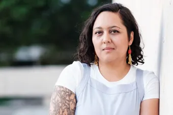  Mercedes Ale Payan Ramirez leaning against a wall