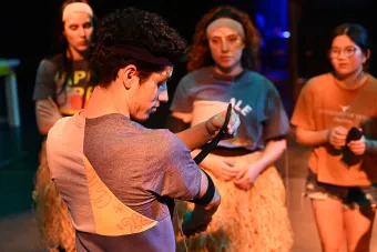 A student dancer attaches motion sensors to his arm 