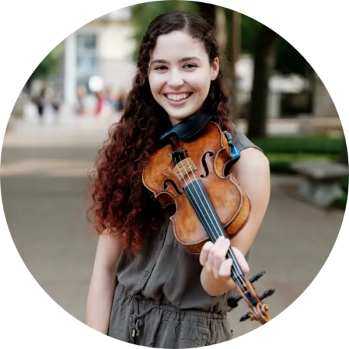 A student holding a violin.