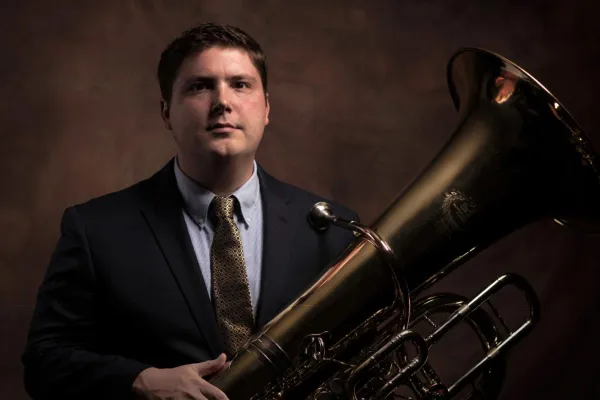 A headshot of Matt Hightower holding his tuba.