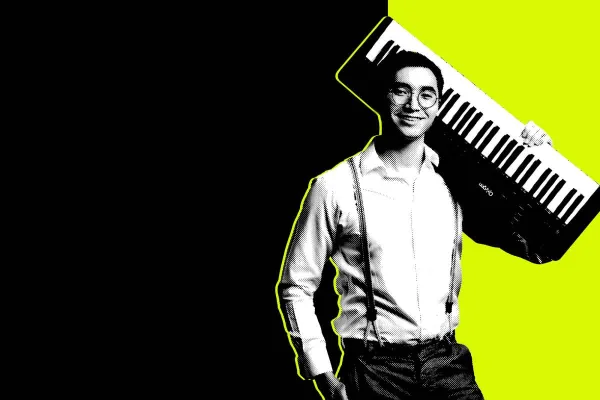 a student holds an electronic keyboard on his shoulder