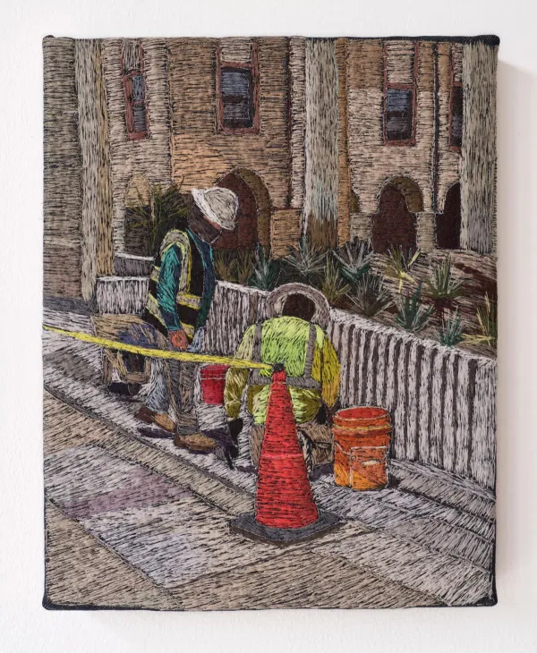 embroidered artwork that portrays utility workers at a manhole in street