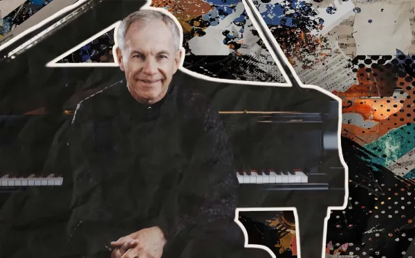 A Headshot of Anton Nel, with the piano behind him. 