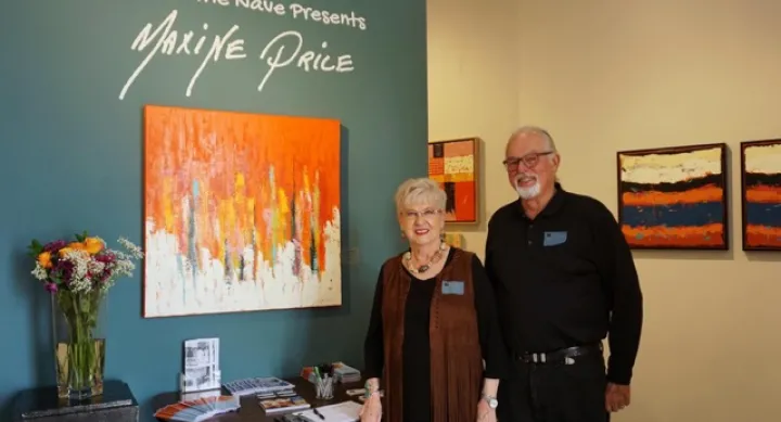 Maxine poses for a photo in front of her painting