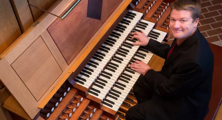 Alvez Barkoskie IV sits in front of an organ