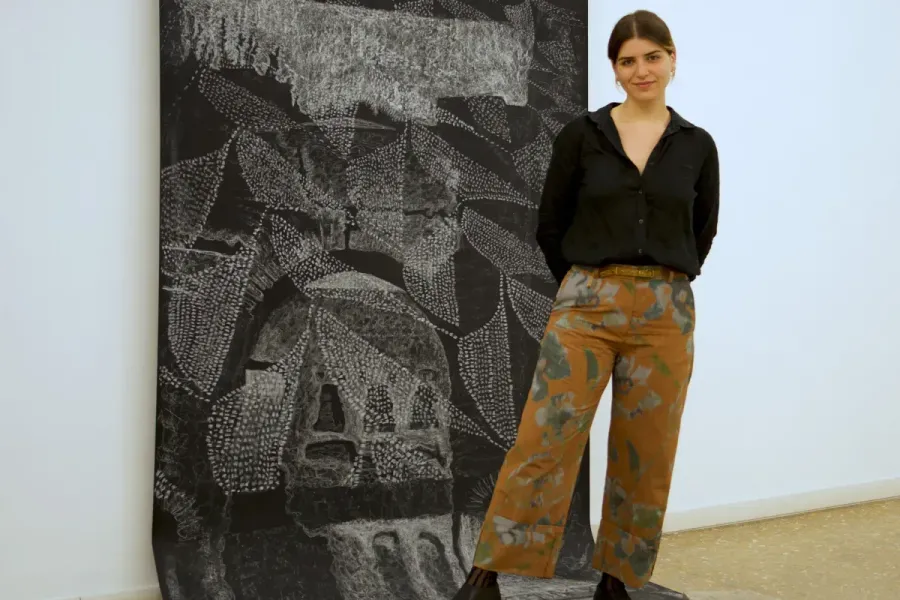 image of a person standing in front of an artwork
