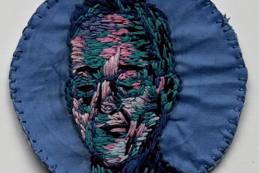 portrait of person rendered in different colored thread
