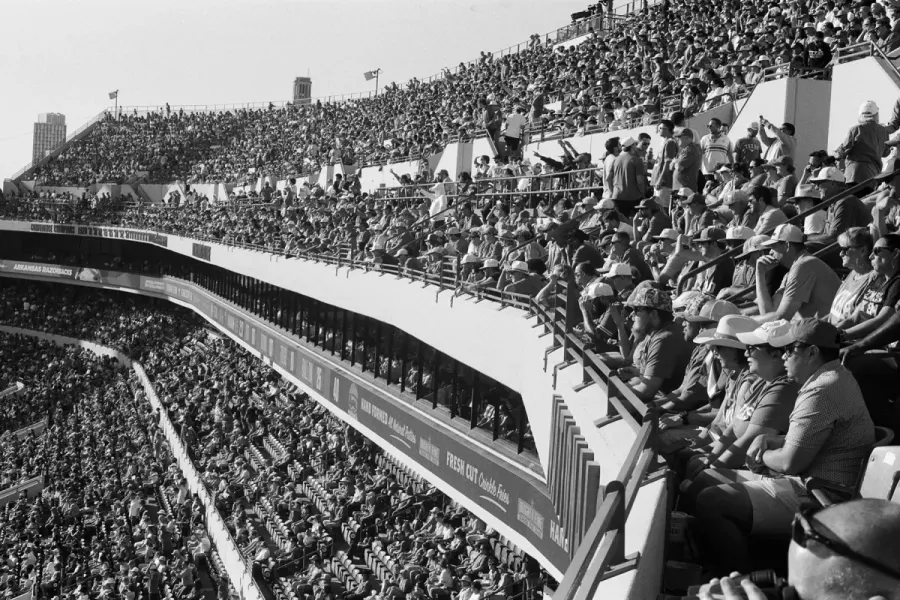 spectator crowd seated in the upper tiers of a football stadium