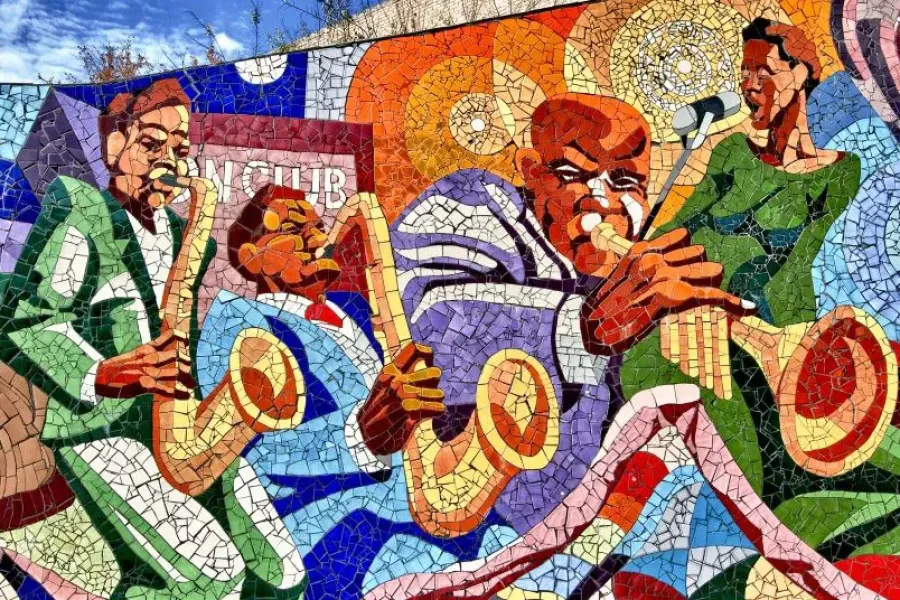 A colorful mosaic mural depicting musicians playing saxophones and trumpets