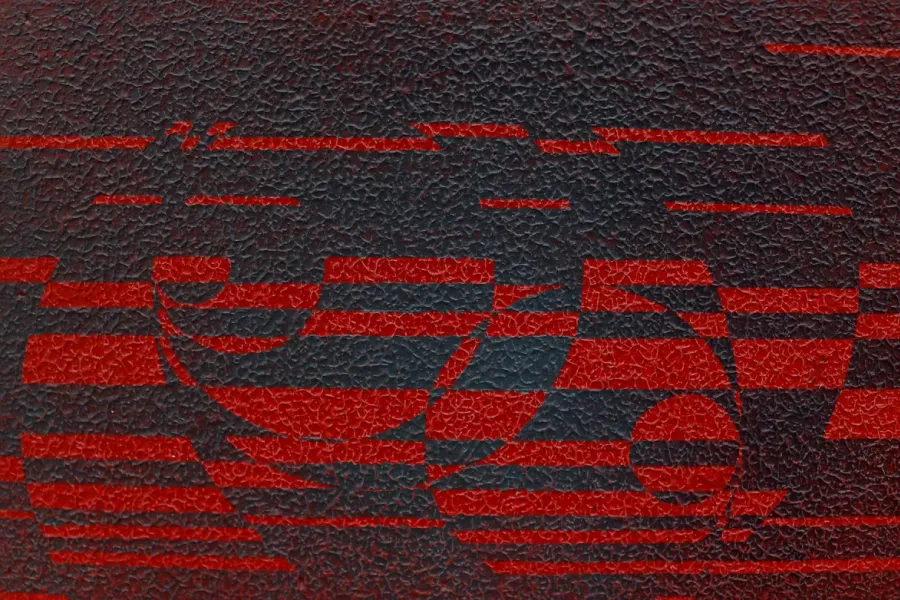 artwork that includes geometric pattern in black and red with a visibly textured surface